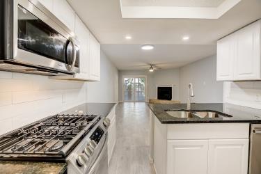 6906 Lovely Lane Austin, TX 78744 - Photo 3 of 20 a kitchen with a stove and a microwave