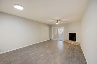 6906 Lovely Lane Austin, TX 78744 - Photo 4 of 20 an empty room with wooden floor and windows