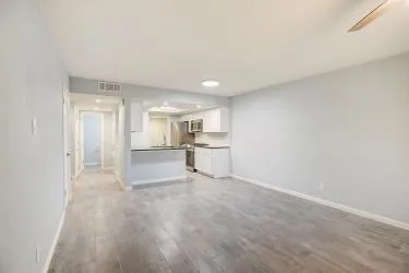 a view of a kitchen with a sink and a refrigerator