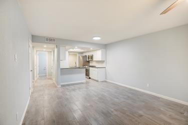 6906 Lovely Lane Austin, TX 78744 - Photo 6 of 20 a view of a kitchen with a sink and a refrigerator