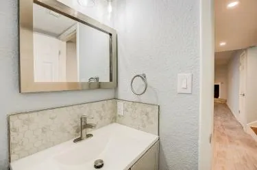 a bathroom with a sink and a large mirror