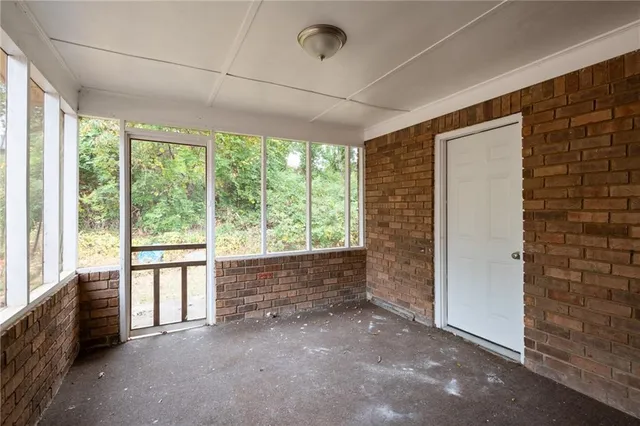 a view of room with wooden floor and furniture