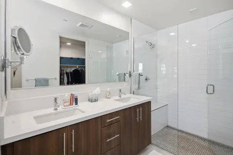 a bathroom with double vanity sinks double vanity and a shower