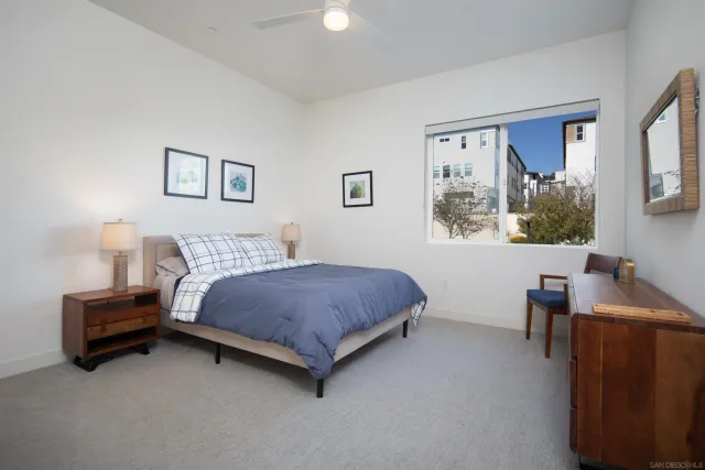 a living room with a bed furniture and a window