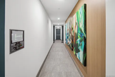 a view of a hallway with wooden floor and stairs
