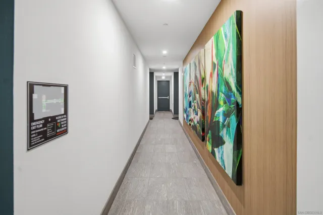 a view of a hallway with wooden floor and stairs