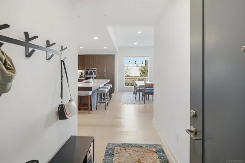 a living room with furniture a wooden floor and a ceiling fan