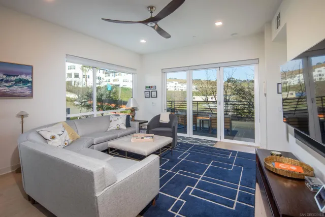 a living room with furniture and a floor to ceiling window