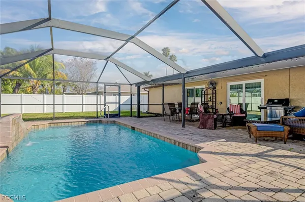 a living room with lots of furniture and a chandelier
