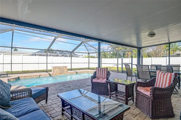 a living room with furniture and floor to ceiling windows