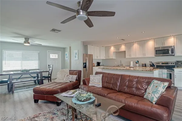 a living room with furniture kitchen view and a table