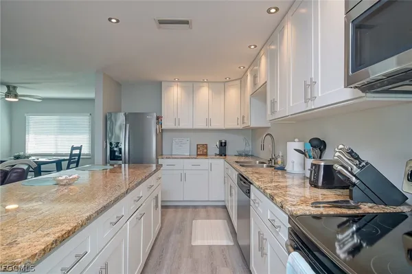 a kitchen with a sink stove top oven and cabinets