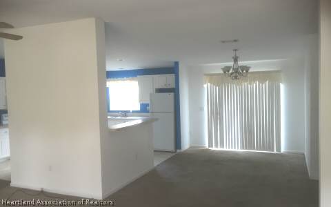 4328 Skipper Road Sebring, FL 33875 - Photo 3 of 8 a view of an empty room with a kitchen