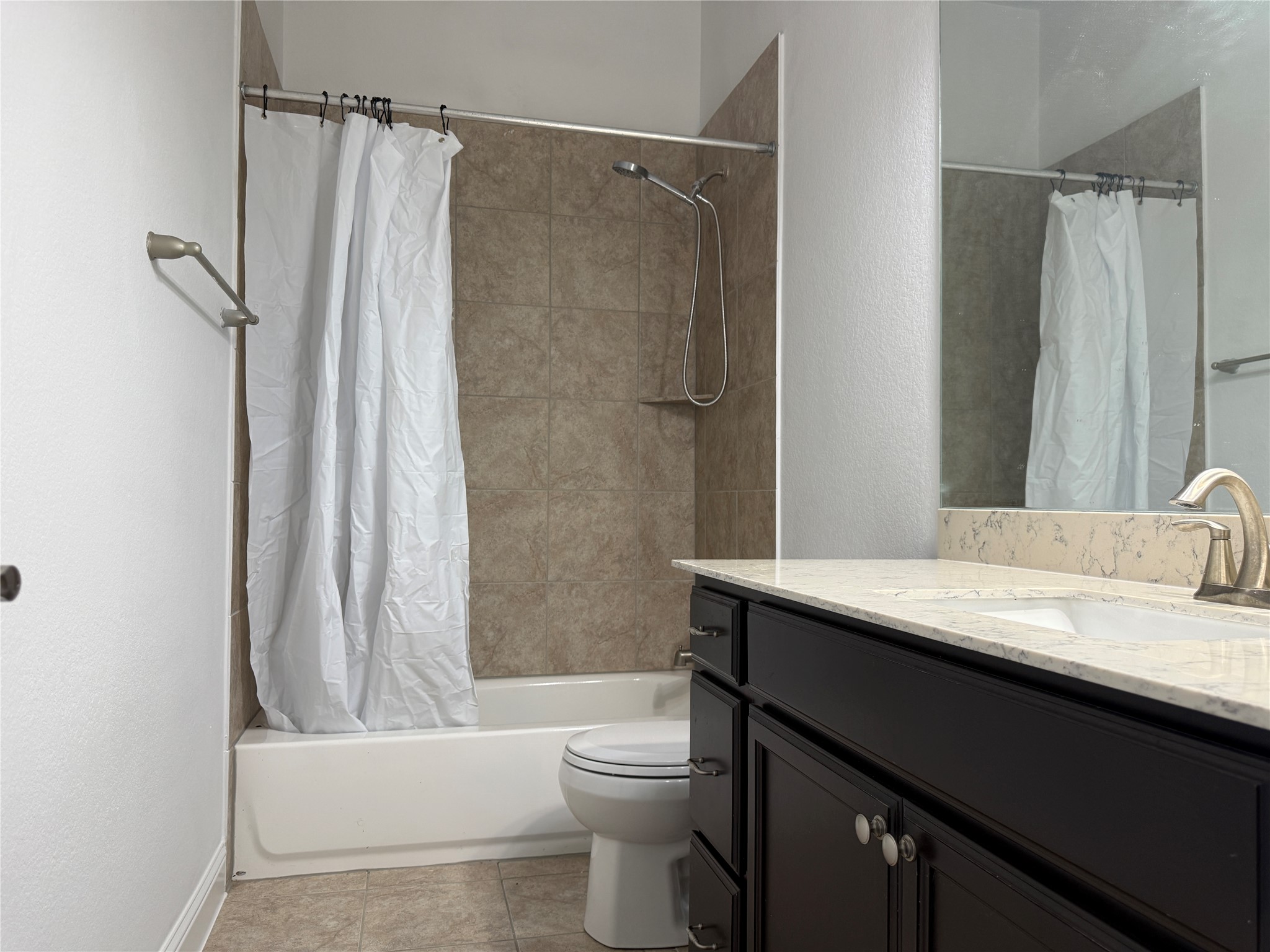 1512 Long Shadow Lane Georgetown, TX 78628 - Photo 17 of 19 a bathroom with a granite countertop sink toilet and shower