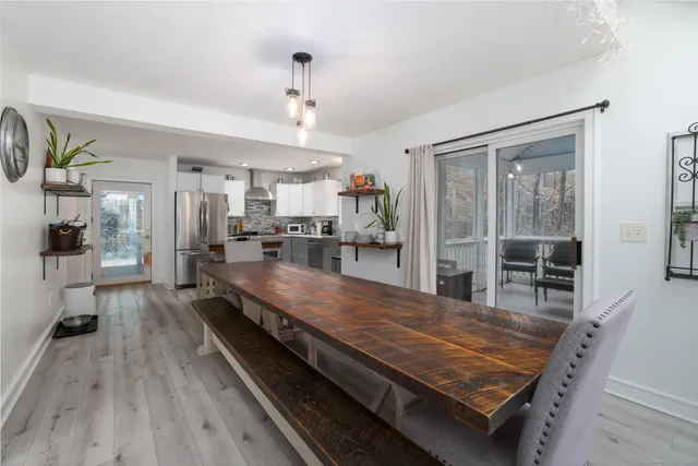 a large kitchen with kitchen island a large counter space a sink stainless steel appliances and cabinets