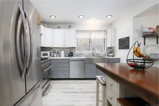 a kitchen with stainless steel appliances a sink stove and refrigerator