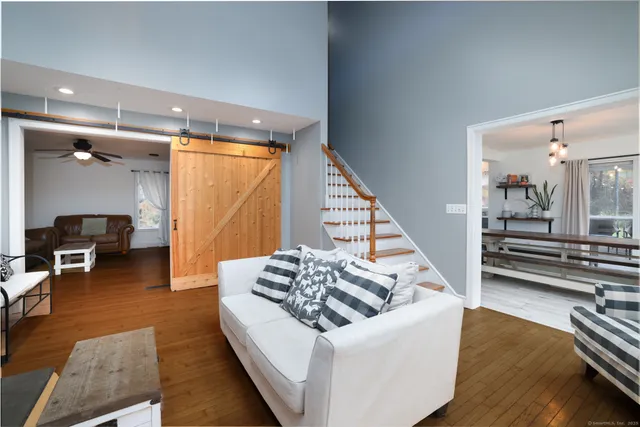 a living room with furniture and a wooden floor