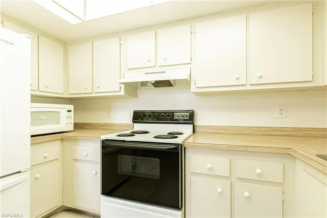 a view of a dining room with furniture and a window
