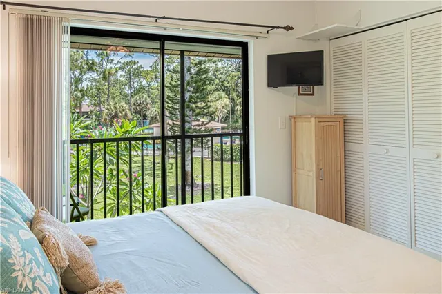 a bedroom with a bed dresser and a window