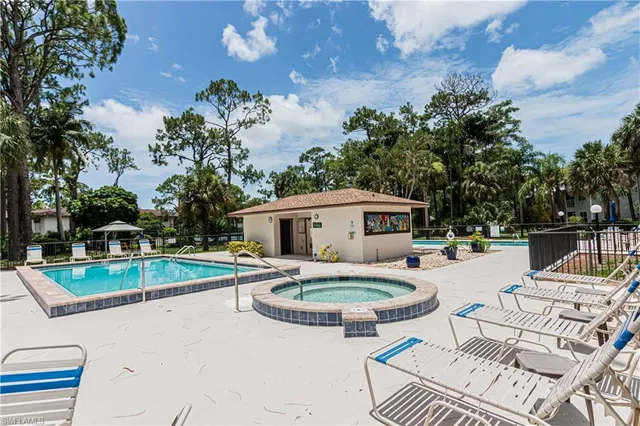 a swimming pool with outdoor seating yard and barbeque oven