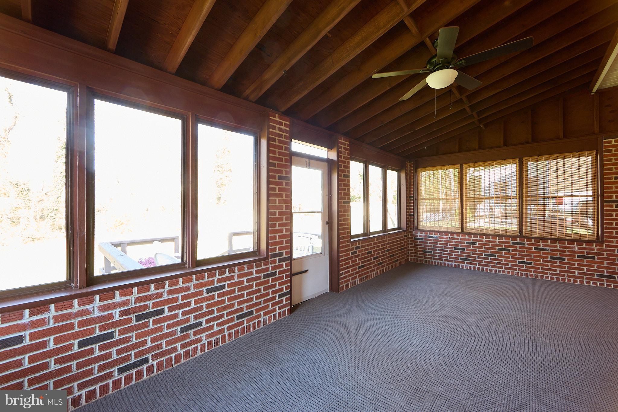 914 Quail Lane Newark, DE 19711 - Photo 20 of 27 Charming sunlit porch with rustic brick walls.