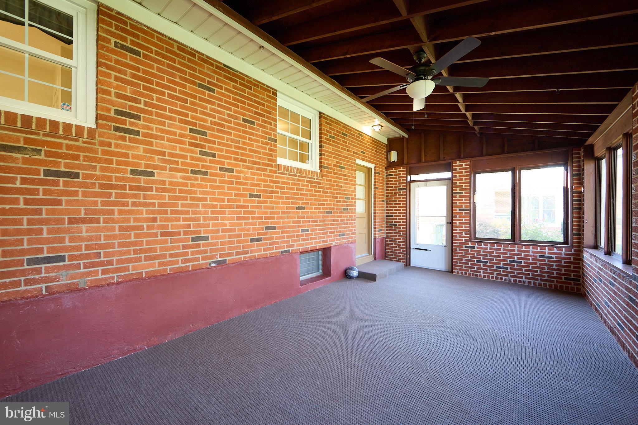 914 Quail Lane Newark, DE 19711 - Photo 21 of 27 Charming sunlit porch with brick accents.