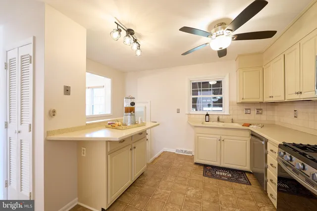 a kitchen with a stove sink and cabinets