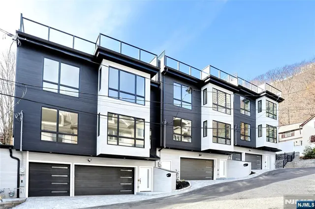 a front view of a house with glass windows