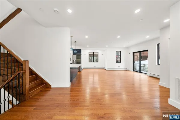 a view of a room with wooden floor and window