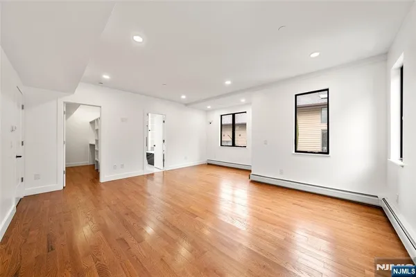 a bathroom with a double vanity sink mirror and tub