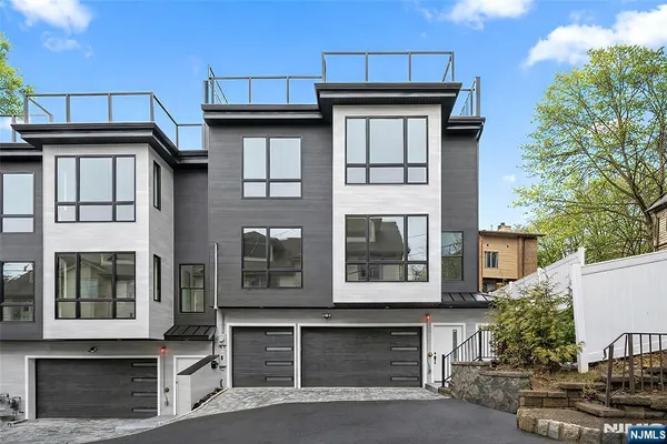 an aerial view of a residential apartment building with a yard and seating area