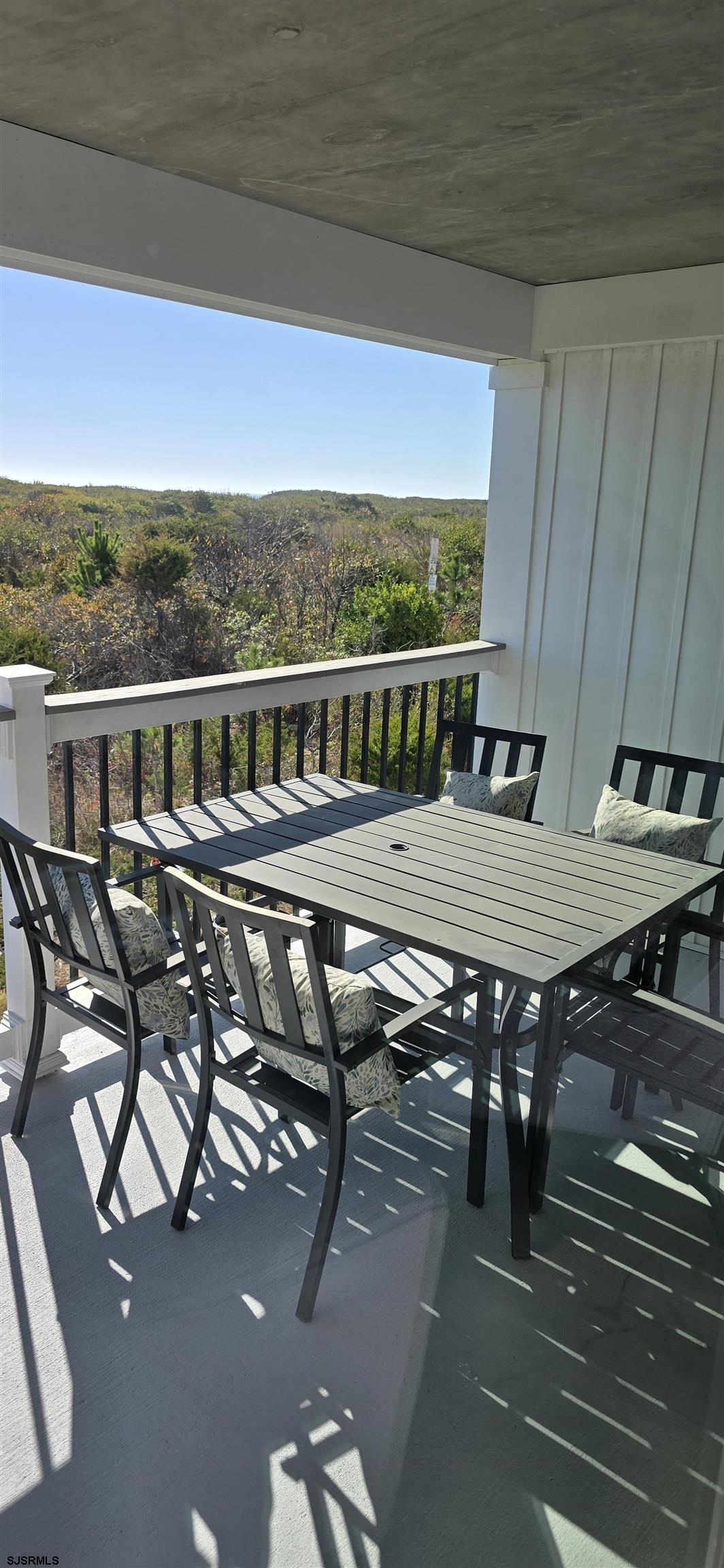 321 6th Street South, Unit 1 Brigantine, NJ 08203 - Photo 15 of 16 a roof deck with a table and chairs