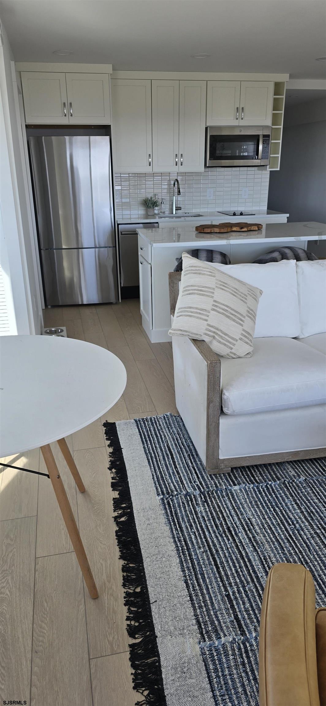 321 6th Street South, Unit 1 Brigantine, NJ 08203 - Photo 9 of 16 a kitchen with stainless steel appliances a stove a sink and cabinets