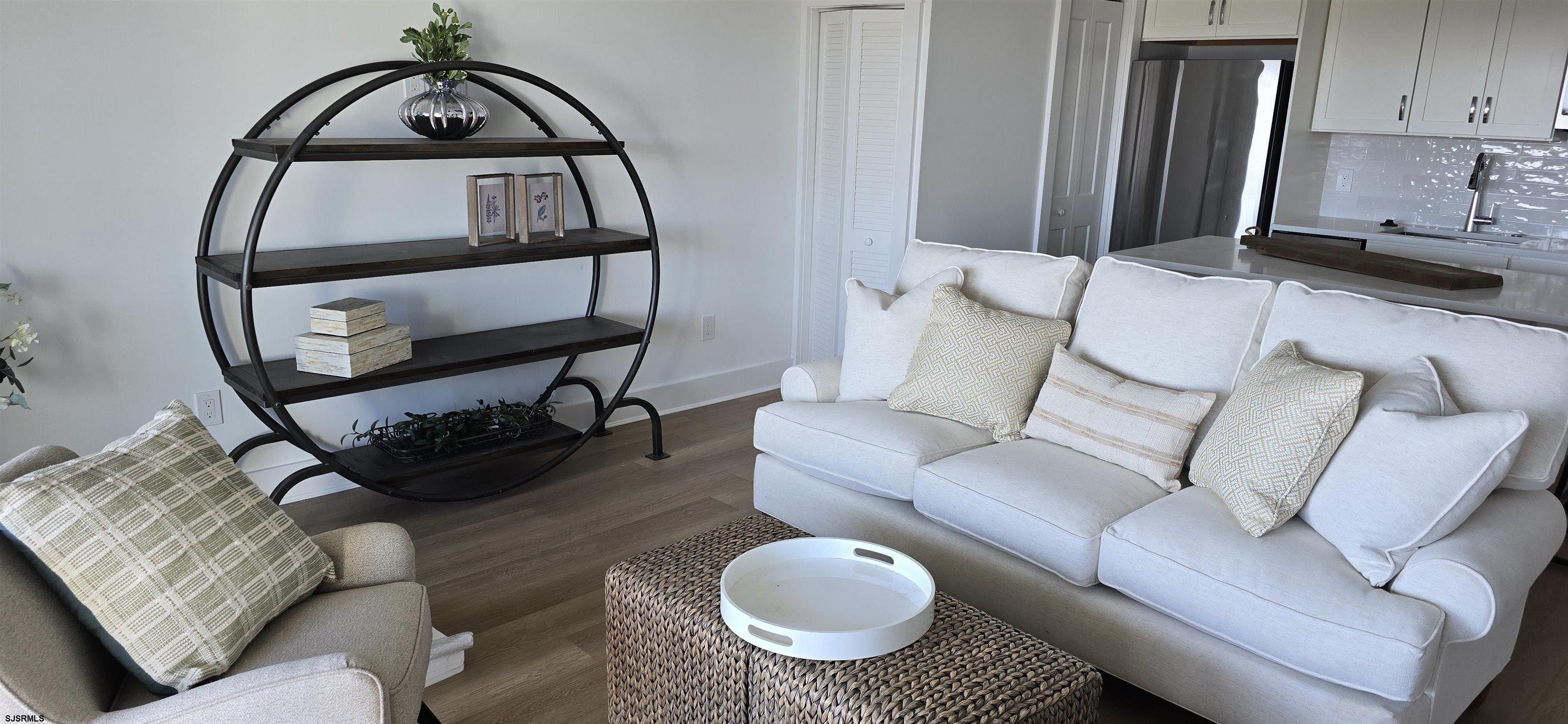 321 6th Street South, Unit 1 Brigantine, NJ 08203 - Photo 10 of 16 a living room with furniture and a mirror