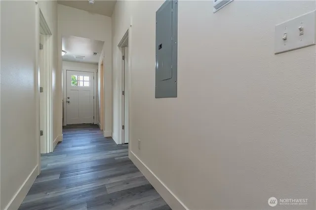 a view of a hallway with wooden floor