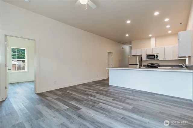 a view of kitchen with wooden floor and window