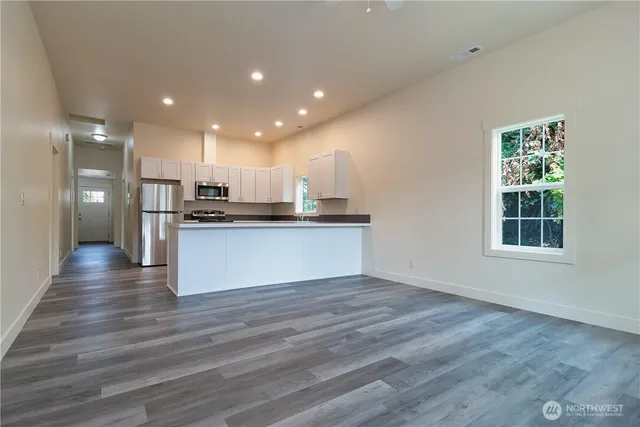 a view of kitchen view wooden floor and window