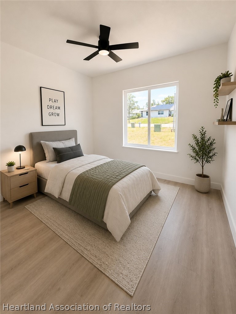 4307 Talbot Street Sebring, FL 33872 - Photo 11 of 19 a bedroom with a large bed and a chandelier