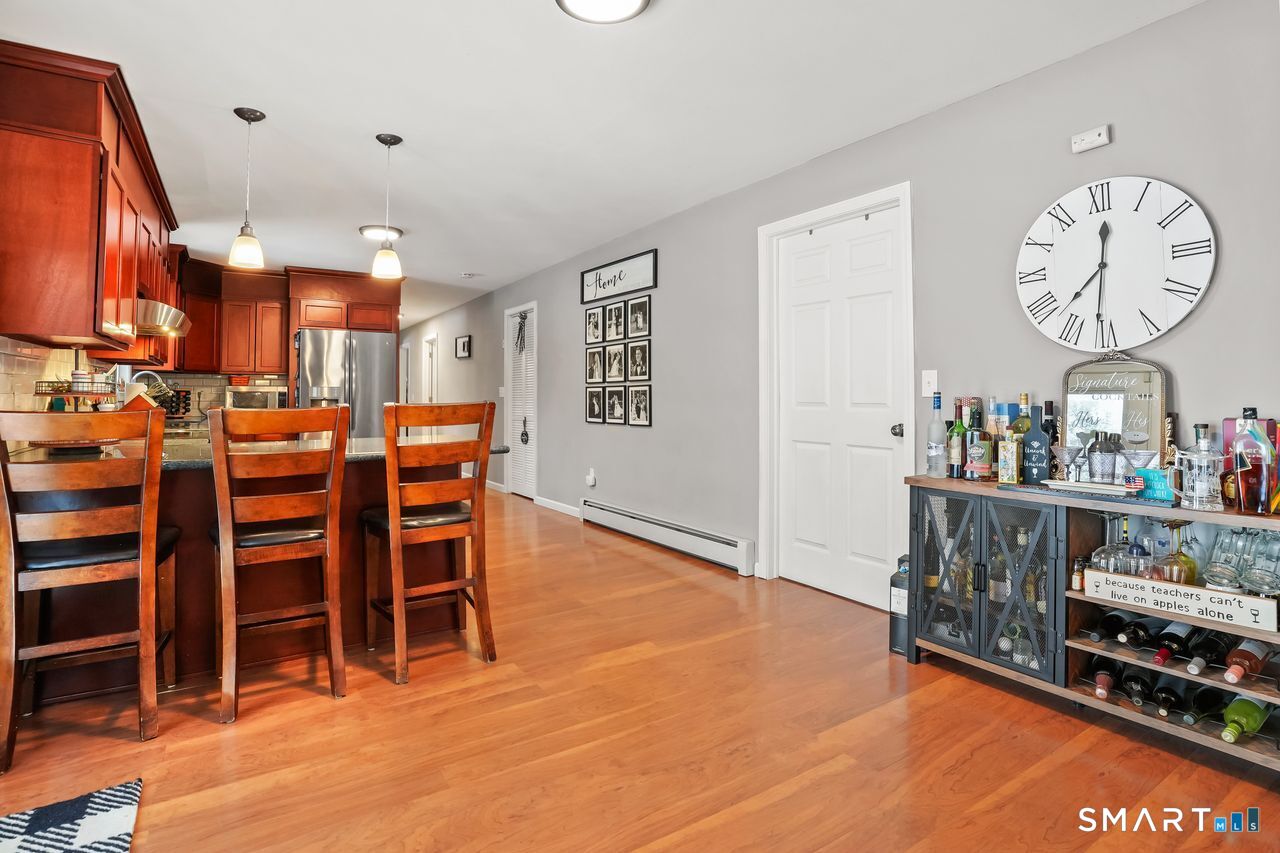 17 Forest View Drive Wolcott, CT 06716 - Photo 12 of 33 a living room with furniture a flat screen tv and kitchen view