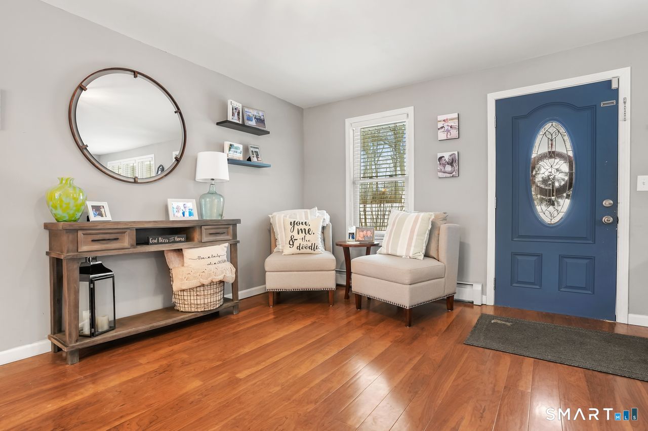 17 Forest View Drive Wolcott, CT 06716 - Photo 7 of 33 a living room with furniture a mirror and wooden floor