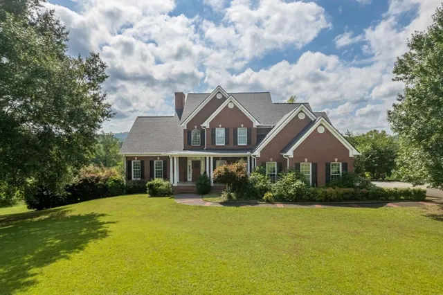 a front view of house with yard and green space