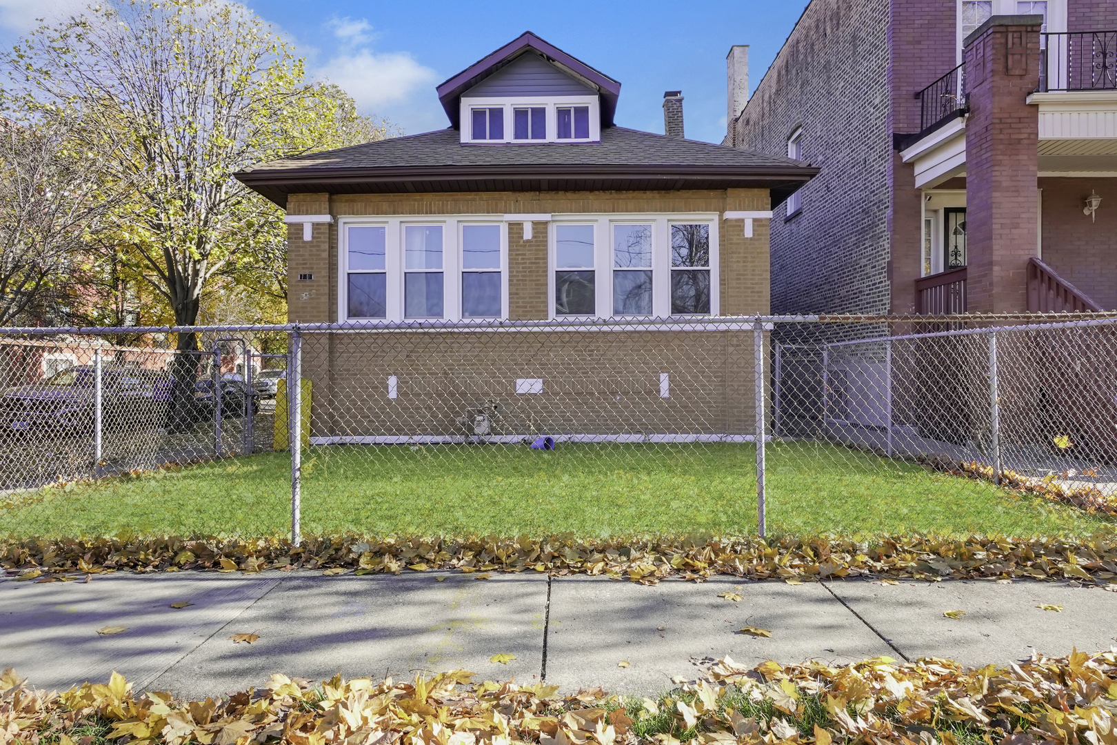 7801 South Ada Street Chicago, IL 60620 - Photo 2 of 7 a front view of a house with a garden
