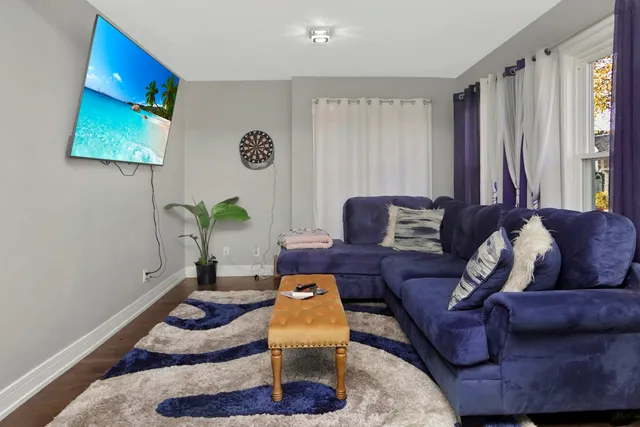 a living room with furniture flowerpot and window