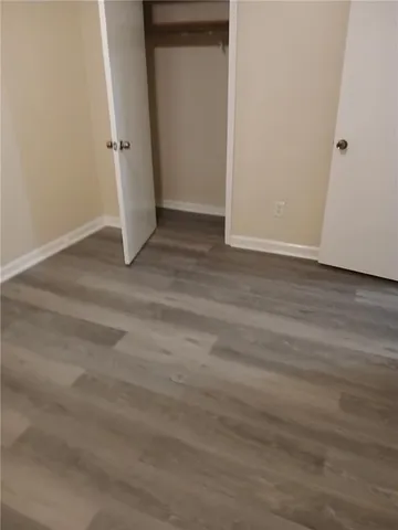 an empty room with wooden floor