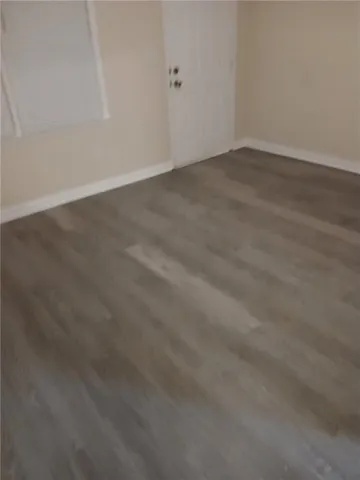 an empty room with wooden floor