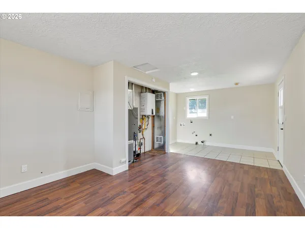 a view of an empty room with wooden floor