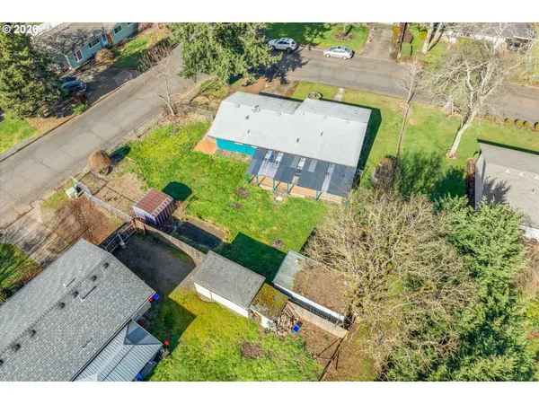 an aerial view of a house with a yard
