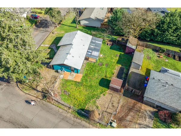 an aerial view of a house with a yard basket ball court and outdoor seating