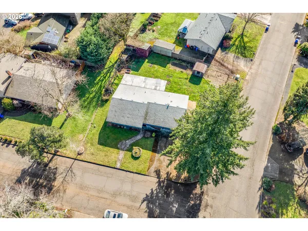 an aerial view of a house with a yard and garden
