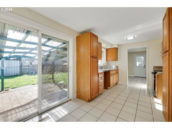 a open kitchen with a sink and refrigerator